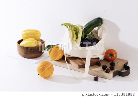 Vegetables and scattered fruits in wooden chopping board eco bags Vegetables and scattered fruits in wooden chopping board eco bags 115391998