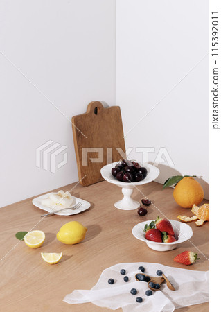 Fruit in the background of a wooden table. A delicious table setting 115392011