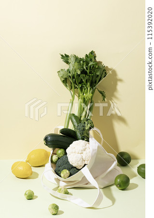 Composition of Green Vegetables and Fruits with Light Yellow Background Composition of Green Vegetables and Fruits with Light Yellow Background 115392020
