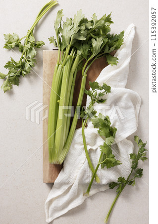 fresh celery handa feet on a wooden chopping board 115392057