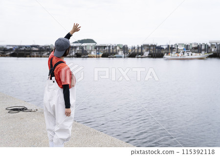 Young woman working at the fishing port 115392118