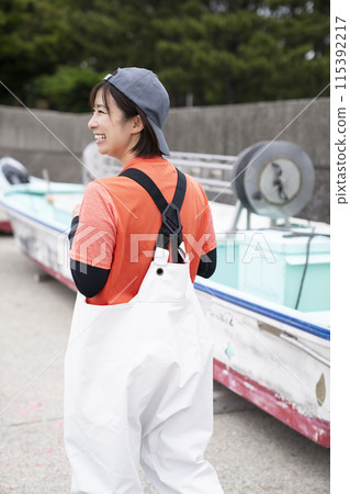 Woman working at fishing port 115392217