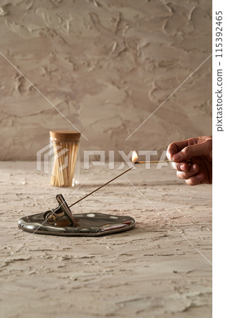 a match lighting insense stick 115392465