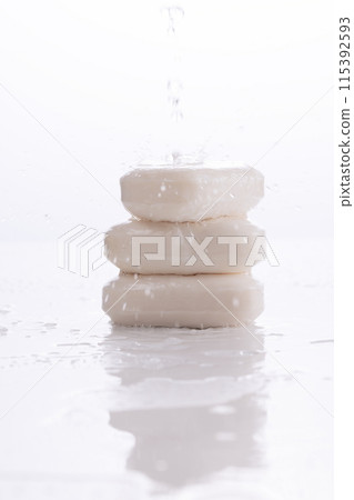 the stream of water and the wet floor falling over the piled soap 115392593