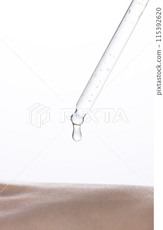 a drop of highly concentrated ampoule on the back of the hand 115392620