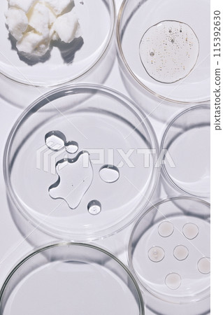 different kinds of ampoules and cream on a petri dish 115392630