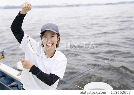 Cute woman enjoying fishing 115392692