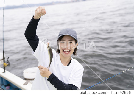 Cute woman enjoying fishing Cute woman enjoying fishing 115392696