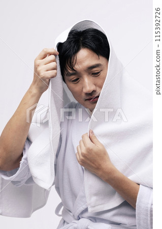a middle aged man with a white towel around his head 115392726