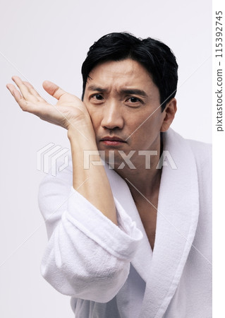 a middle aged man with his wrist on his cheek 115392745