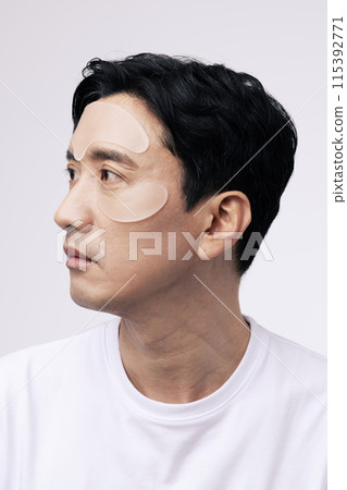 a middle aged man with a cosmetic patch on his face 115392771
