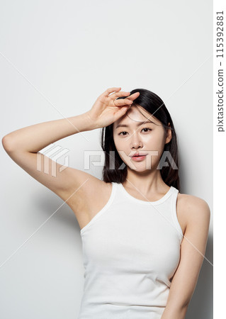 Asian Woman Poses Against White Background 115392881