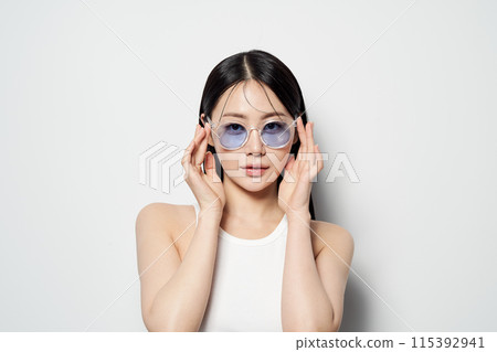 Asian Woman Poses With Sunglasses Asian Woman Poses With Sunglasses 115392941