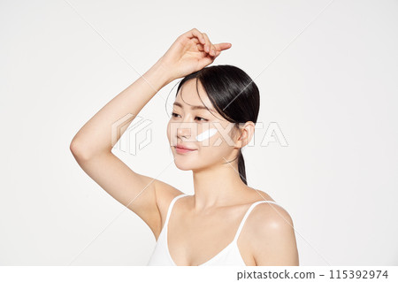 Asian Woman Poses With Cream on Her Face Asian Woman Poses With Cream on Her Face 115392974