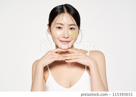 Asian Woman Poses With Eyepatch on Her Face Asian Woman Poses With Eyepatch on Her Face 115393031
