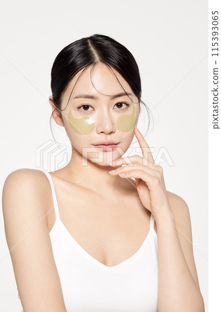 Asian woman posing with eye patches on both cheeks Asian woman posing with eye patches on both cheeks 115393065