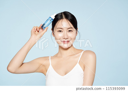 Asian woman posing with eye patches on both cheeks Asian woman posing with eye patches on both cheeks 115393099