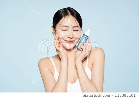 Asian woman posing with eye patches on both cheeks 115393101