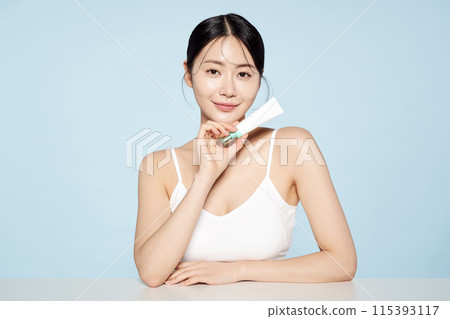 Asian Woman Poses With White Eye Cream Asian Woman Poses With White Eye Cream 115393117