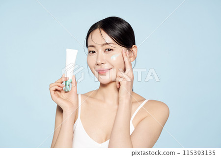 Asian Woman Poses With Cream Around Her Eyes Asian Woman Poses With Cream Around Her Eyes 115393135