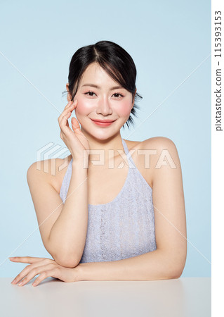 Asian woman wearing light purple string sleeveless and touching her face Asian woman wearing light purple string sleeveless and touching her face 115393153