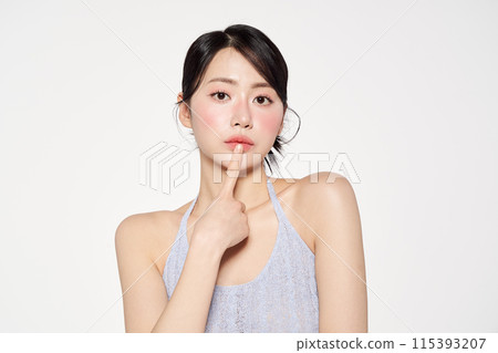 Asian Woman Poses Touching Her Lips Asian Woman Poses Touching Her Lips 115393207