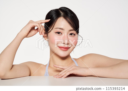 an Asian woman touching her hair with her fingers 115393214