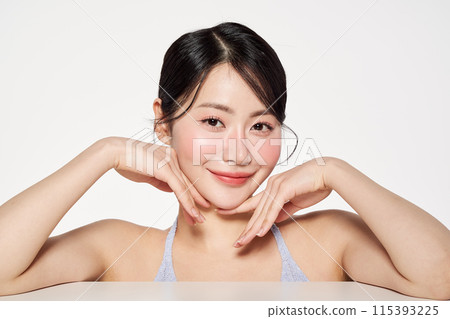 Asian Woman Poses Touching Her Face 115393225