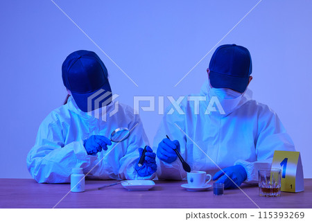 CSI Scientific Investigation Unit male and female researchers collecting fingerprints from crime and incident sites with blue lights and checking evidence with magnifying glass CSI Scientific Investigation Unit male and female researchers collecting fingerprints from crime and incident sites with blue lights and checking evidence with magnifying glass 115393269