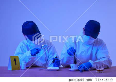 CSI Scientific Investigation Unit male and female researchers collecting fingerprints from crime and incident sites with blue lights and checking evidence with magnifying glass CSI Scientific Investigation Unit male and female researchers collecting fingerprints from crime and incident sites with blue lights and checking evidence with magnifying glass 115393272