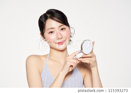 Asian Woman Wearing Cushion Facts in the Mirror 115393273