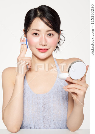 Asian Woman Putting Cushion Facts on Her Face Asian Woman Putting Cushion Facts on Her Face 115393280