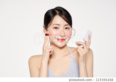 a beautiful Asian woman who puts cushion compacts on her face a beautiful Asian woman who puts cushion compacts on her face 115393288