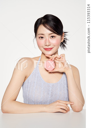Asian Woman Smiling With Pink Cushion Fact 115393314