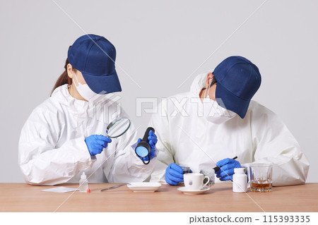 Researchers from the CSI Scientific Investigation Unit identifying evidence and collecting fingerprints at crime and incident sites 115393335