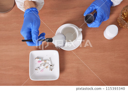 The hand of a CSI Scientific Investigation Unit researcher who is checking evidence and collecting fingerprints at crime and incident sites 115393340