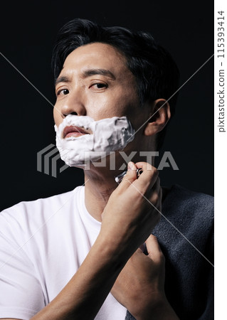 a middle aged man about to start shaving a middle aged man about to start shaving 115393414