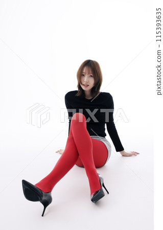 Korean Woman Sitting on the Floor in Red Leggings and Crossing Her Legs Korean Woman Sitting on the Floor in Red Leggings and Crossing Her Legs 115393635