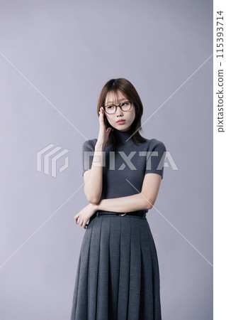 A Korean woman in her 20s who wears a geek-look Style and touches a spectacle frame with one hand A Korean woman in her 20s who wears a geek-look Style and touches a spectacle frame with one hand 115393714