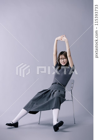 Korean Woman in 20s Stretching in Chair with Legs Stretching Korean Woman in 20s Stretching in Chair with Legs Stretching 115393733