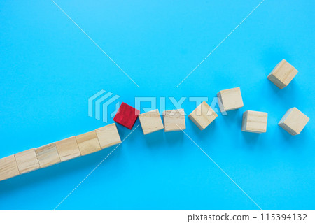 The red cube as an unexpected problem or obstacle breaks the line. The red cube as an unexpected problem or obstacle breaks the line. 115394132
