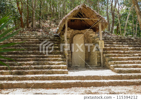 ancient Mayan inscribed stele in Coba ruins archaeological site. Mexico 115394212