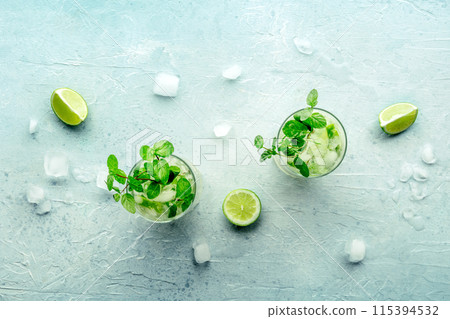 Mojito cocktail. Summer cold drink with lime, fresh mint, and ice. Cool beverage 115394532