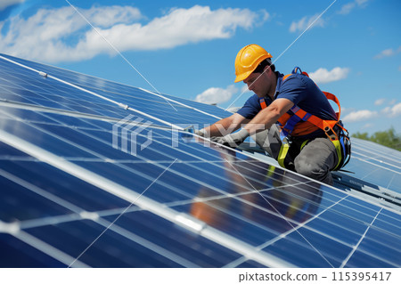 An engineer installs and adjusts the operation of solar panels 115395417