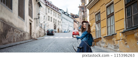 Female traveller on electric scooter in small city, sightseeing. Young tourist using bike during her summer solo trip, vacation. Banner with copy space. Female traveller on electric scooter in small city, sightseeing. Young tourist using bike during her summer solo trip, vacation. Banner with copy space. 115396263