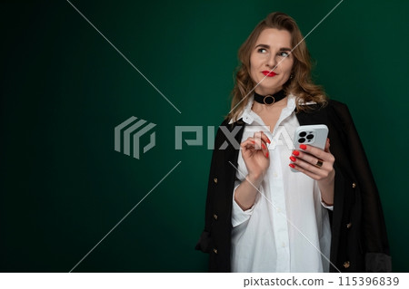Woman in White Shirt Holding Cell Phone Woman in White Shirt Holding Cell Phone 115396839