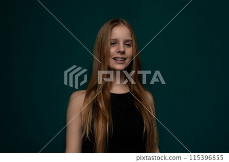 Woman With Long Red Hair in Front of Green Background Woman With Long Red Hair in Front of Green Background 115396855