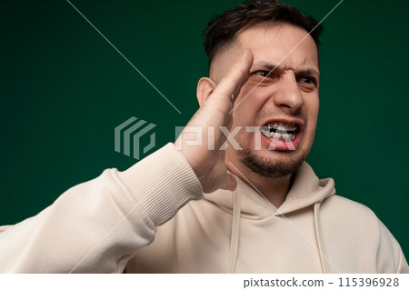 Man Holding Hand Up to Face Man Holding Hand Up to Face 115396928