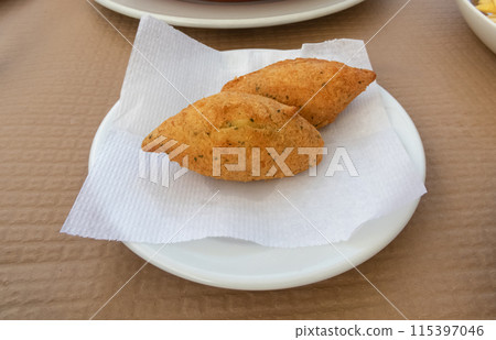 Bolinhos de bacalhau or pasteis de bacalhau on the plate 115397046