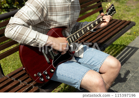 A man plays a beautiful guitar close-up 115397196